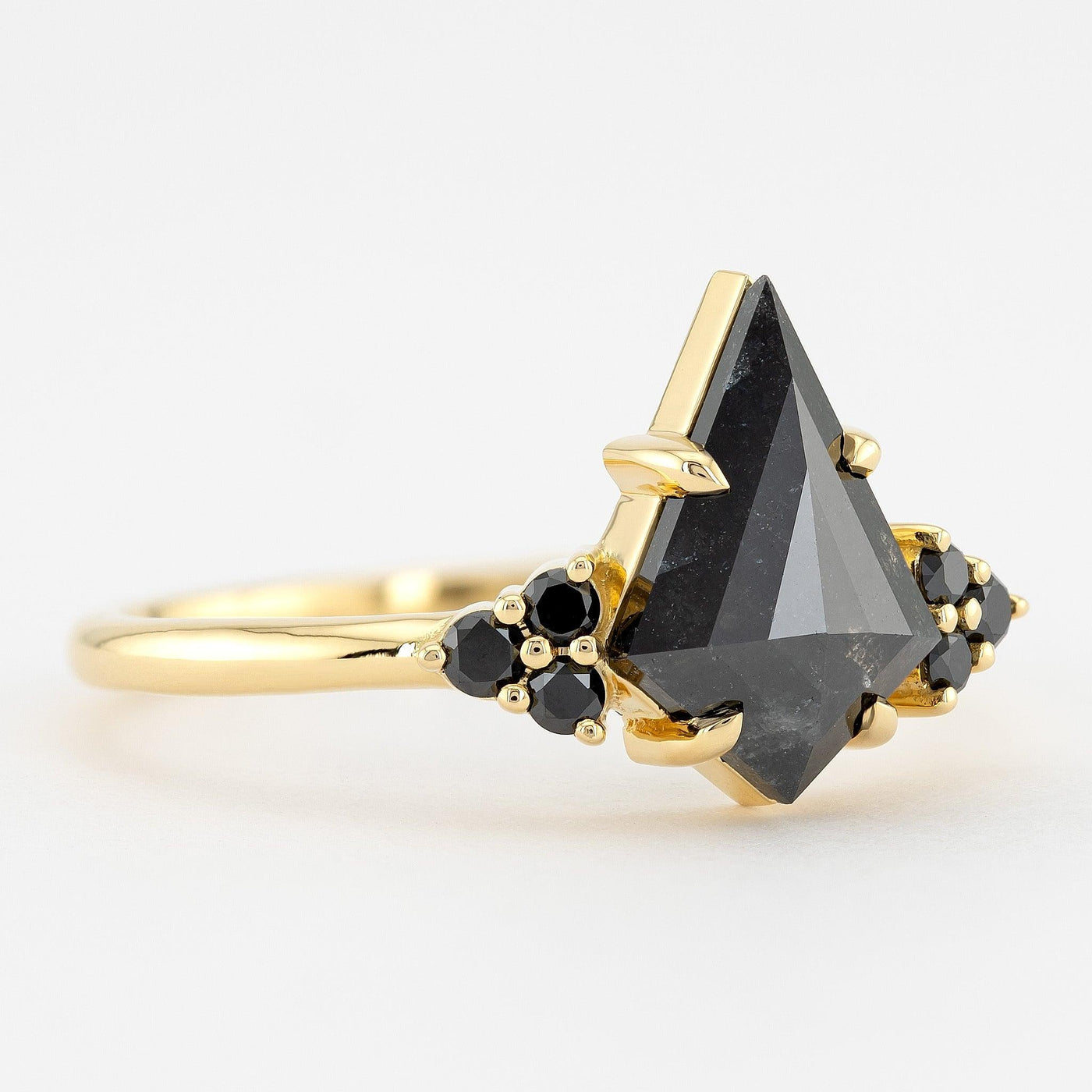 Kite diamond ring with side stone black diamond eagle prongs setting