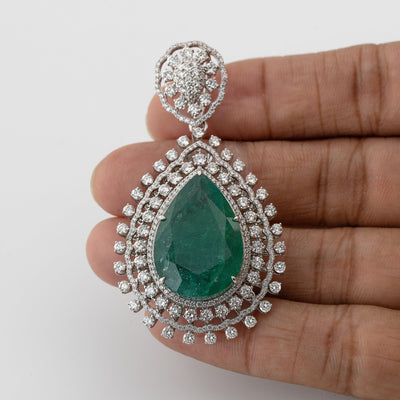 Green emerald color pear shaped pendant with white diamond halo setting