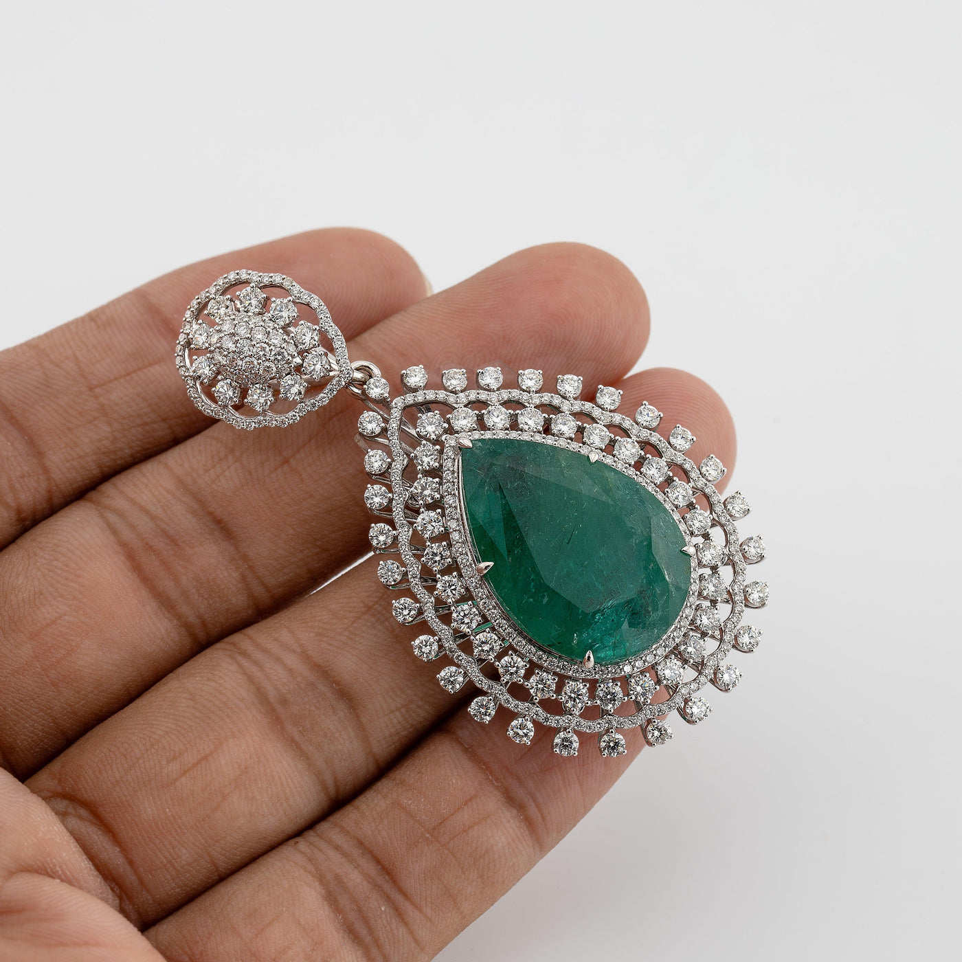 Green emerald color pear shaped pendant with white diamond halo setting - Rubysta