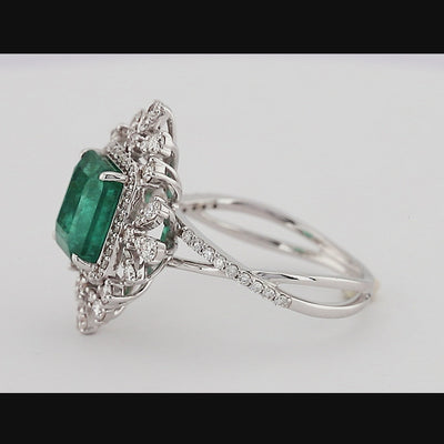 Vintage emerald shaped green emerald color with split shank, eagle prongs and halo setting engagement ring